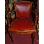 An early 20th century mahogany and red rexine studded upholstered pad back and seat tub desk