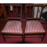 A pair of 19th century mahogany dining chairs, with striped upholstered drop-in pad seats