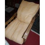 An early 20th century oak slatted and barleytwist framed reclining armchair, with removable