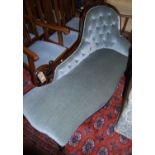 A mid-Victorian figured walnut showframe buttoned upholstered chaise-longue, raised on squat