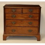 A George III mahogany squarefront chest, having a crossbanded top over two short and three long