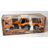 A Nikko radio controlled 27MHZ 1/18 scale Renault tractor and farm trailer, appears as issued,