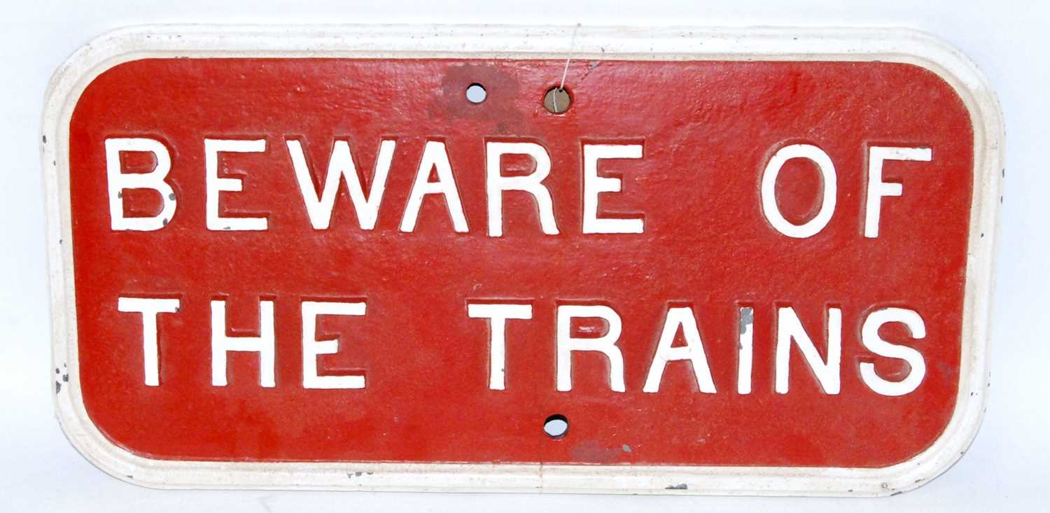 A small cast iron Southern Railway oblong white on red 'Beware of the Trains' warning