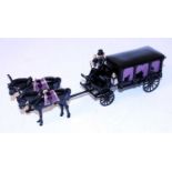 An STE Limited dated 1988 white metal horse drawn model of a four wheel hearse, finished in black