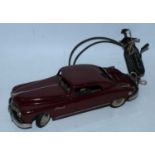 An Arnold tinplate and mechanical Primal Saloon comprising of maroon body with white wall tyres,