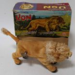 A Marx Toys mechanical, mohair and clockwork model of a growling lion housed in the original card