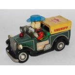 A TN Nomura tinplate and battery operated model of a Sheriff's covered delivery wagon comprising