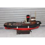 A GRP wooden kit built model of a Krakatoa tug boat comprising of red, black and white painted