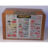 Six drawer Meccano dealer's cabinet, light oak, with header board and show card, containing an