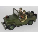 A TN Nomura tinplate and battery operated model of a military jeep with driver and attendant figure,