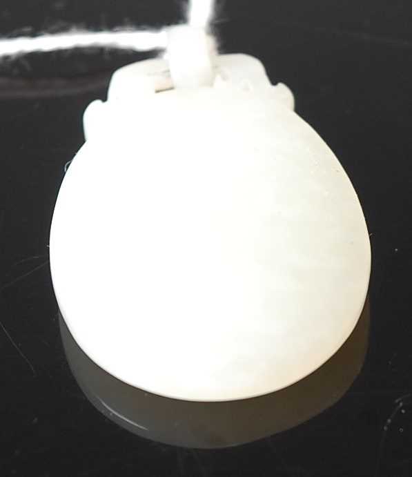 A Chinese pale celadon jade pendant, 41mm (excluding bale), 17.4g