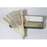 A late 19th century lady's fan, having faux carved ivory sticks with silk dividers, boxed with label