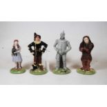 A set of four Royal Doulton Wizard of Oz figures, to include Dorothy No.1197, Scarecrow No.1232,