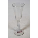 An 18th century continental liqueur glass, having elongated bell-shaped bowl on a double opaque