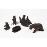 A collection of four Black Forest style carved softwood figures of bears, in various poses, the