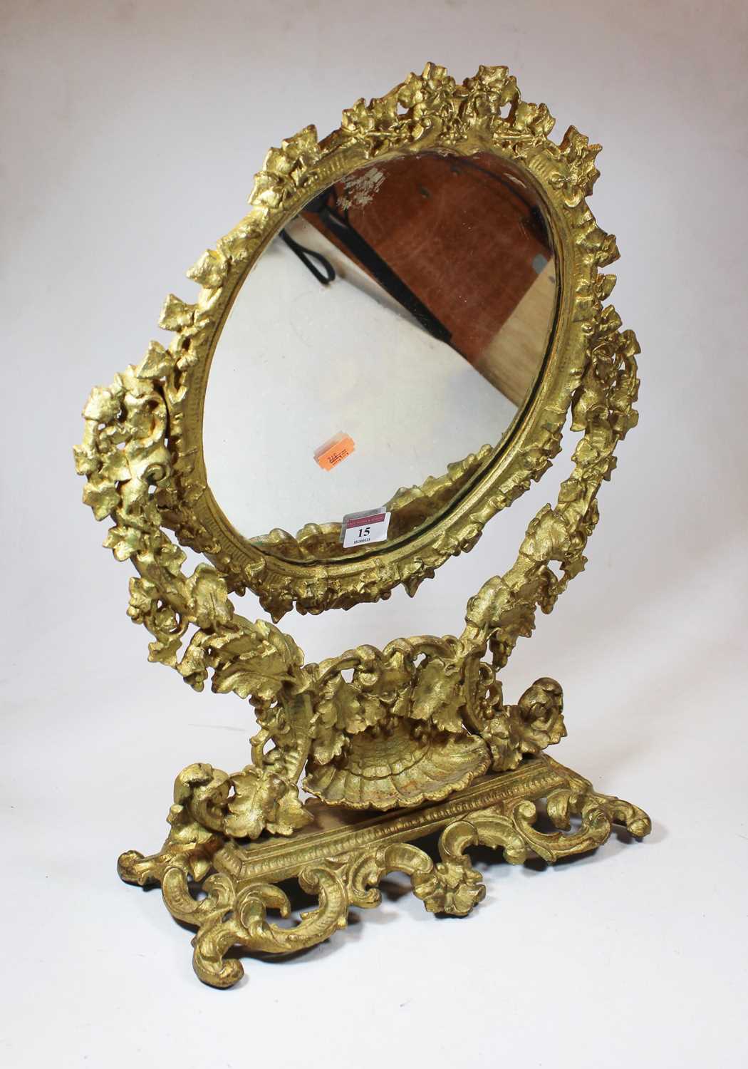 A 19th century gilt metal swing framed toiletry mirror, with scrolled and foliate decoration, h.