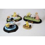 A collection of four Royal Doulton Winnie the Pooh figures, to include Summer's Day Picnic No.635 of