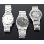 Three gent's Seiko Five sports automatic wristwatches, each with day-date apertures