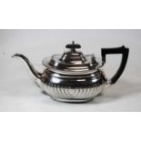 A George V silver plated teapot, of half-gadrooned oval form, with presentation inscription '