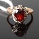 A 9ct yellow and white gold, garnet and diamond oval cluster ring, the garnet measuring approx 8.9 x