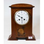 An early 20th century mahogany and boxwood strung mantel clock, having eight day movement, the