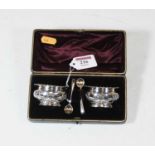 A pair of George V silver open salts, having wavy rims and relief decorated with swags and bows,