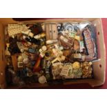 A box of assorted dolls house furniture and china to include three drawer chest, dressing table,