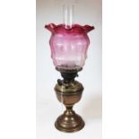 A Victorian brass oil lamp, with acid etched cranberry glass shade, h.51cmCondition report: Shade