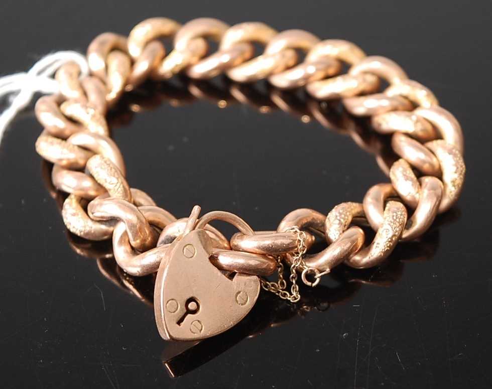 A 9ct gold hollow curblink bracelet, with heart shaped padlock clasp and safety chain, 27.8g