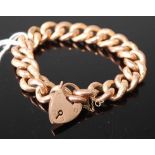 A 9ct gold hollow curblink bracelet, with heart shaped padlock clasp and safety chain, 27.8g
