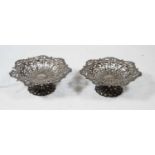 A pair of Edwardian silver bonbon dishes, of shaped circular form, having pierced borders, on fluted