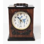 A late Victorian walnut cased mantel clock, the circular dial with Arabic numerals and printed