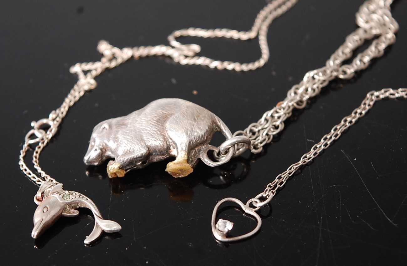 A white metal pendant, fashioned as a squirrel, on a multi-link neck chain; together with one