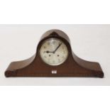 A 1930s oak cased eight day mantel clock, the silvered dial showing Arabic numerals, the case with