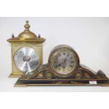 An early 20th century black lacquered and chinoiserie decorated mantel clock, having a silvered dial