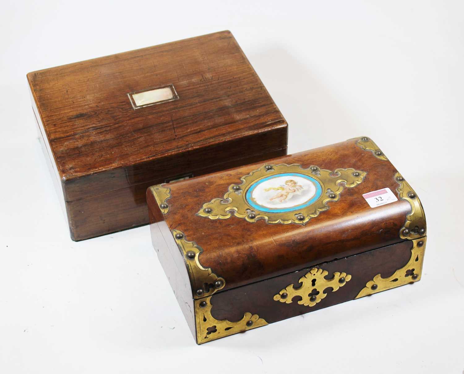 A Victorian walnut and brass mounted box, the hinged lid inset with an oval porcelain plaque