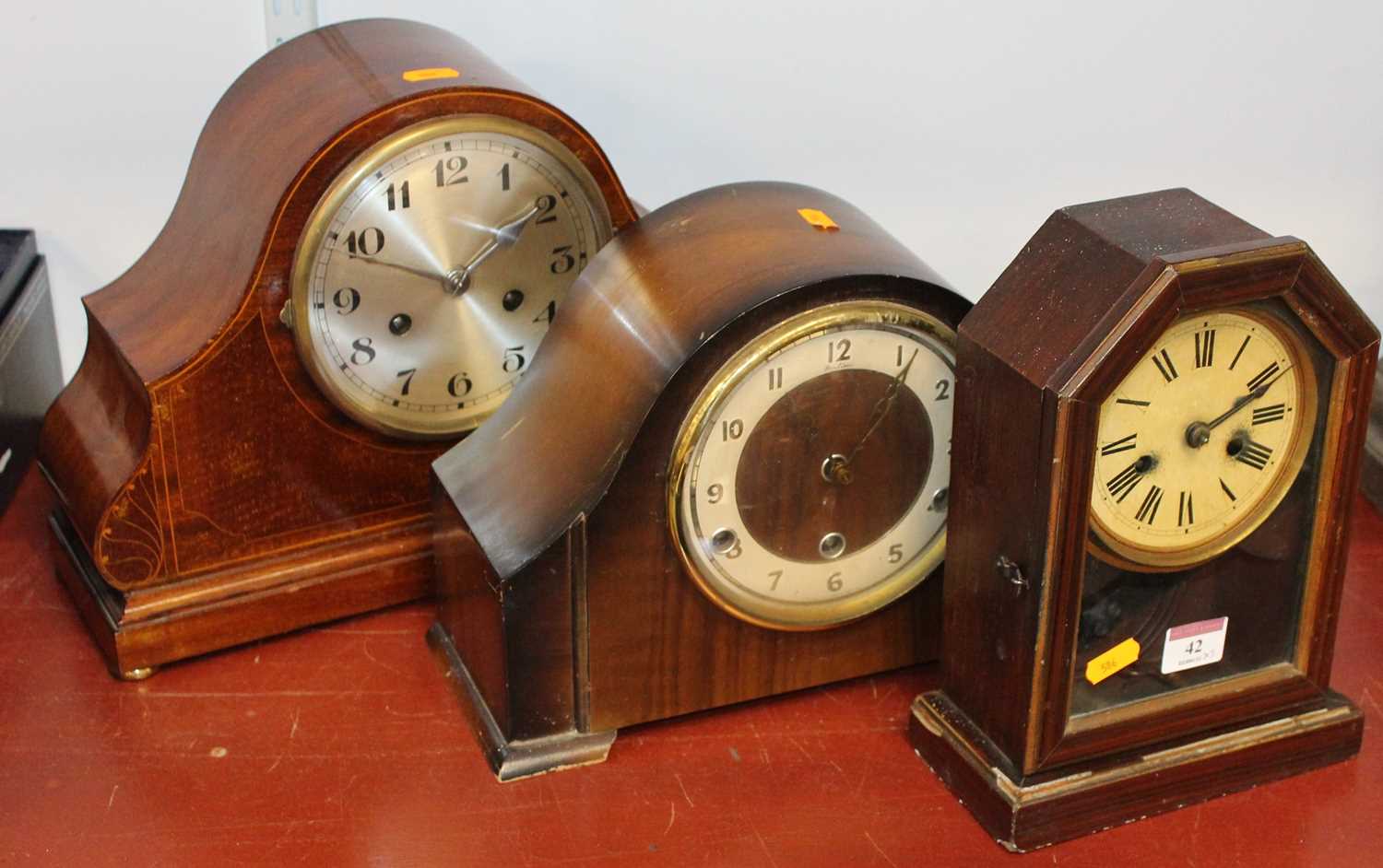 An early 20th century mahogany and boxwood strung 8-day mantel clock, the silvered dial showing