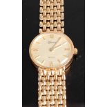 A 9ct yellow gold lady's Geneve quartz wristwatch, having a round champagne quarter Roman dial,