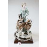 An Italian bisque figure of a Lady with two dogs by Giuseppe Armani, mounted on a moulded wooden