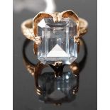 A 9ct gold blue topaz set dress ring, the four claw set baguette cut topaz measuring approx 12 x 9 x