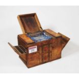 A 1930s novelty table-top cigarette dispenser in the form of a walnut sideboard, the hinged lid