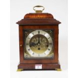 An 18th century style walnut bracket clock, the silvered chapter ring showing Roman numerals, the