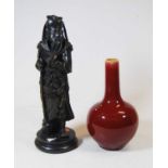 A Chinese export Sang de Boeuf bottle vase, the cylindrical neck above a globular body, 18cm high,