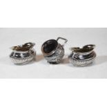 A pair of Edwardian silver open salts, of squat oval form, with half-reeded decoration; together