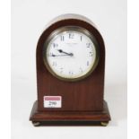 An Edwardian mahogany cased dome-top mantel clock, having a convex enamelled dial with Arabic
