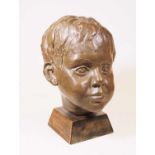 A 20th century bronzed portrait bust of a boy, mounted on a wooden plinth, h.26cmCondition report: