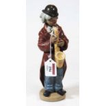 A Lladro Spanish porcelain model of a Clown Musician, matt finish, printed Lladro mark verso and