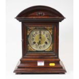 A late 19th century oak cased mantel clock, having eight day movement, the silvered chapter ring