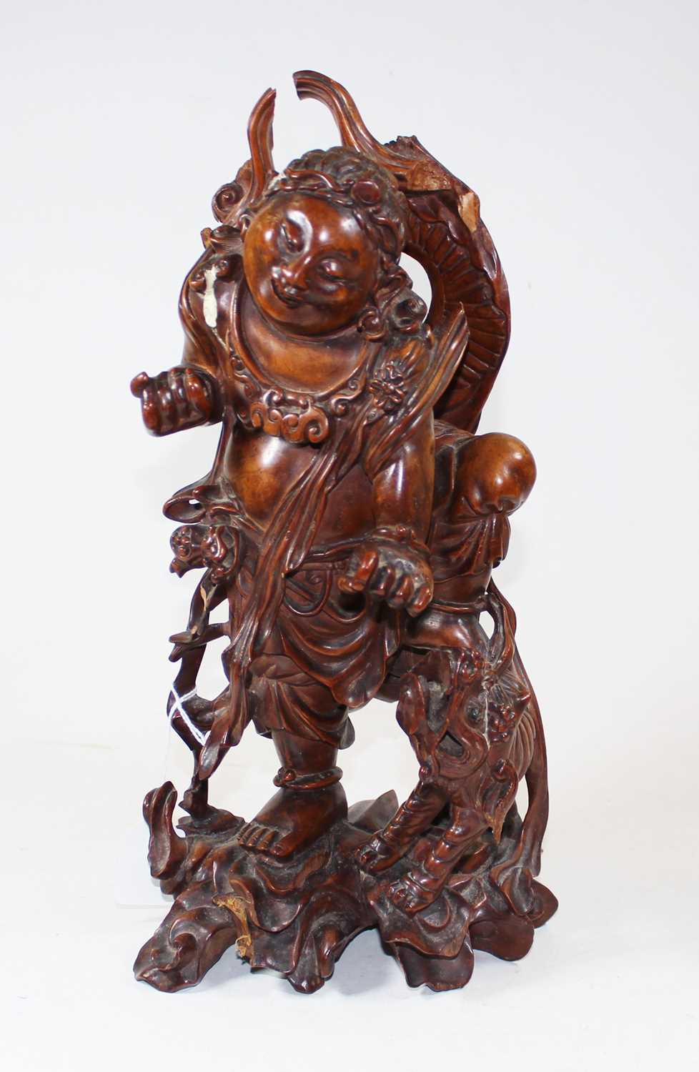 An early 20th century carved wood figure of a gentleman, probably Taisho period, shown standing with