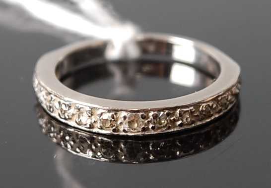 A white metal diamond 14-stone half hoop eternity ring, featuring Old European and rose cut diamonds